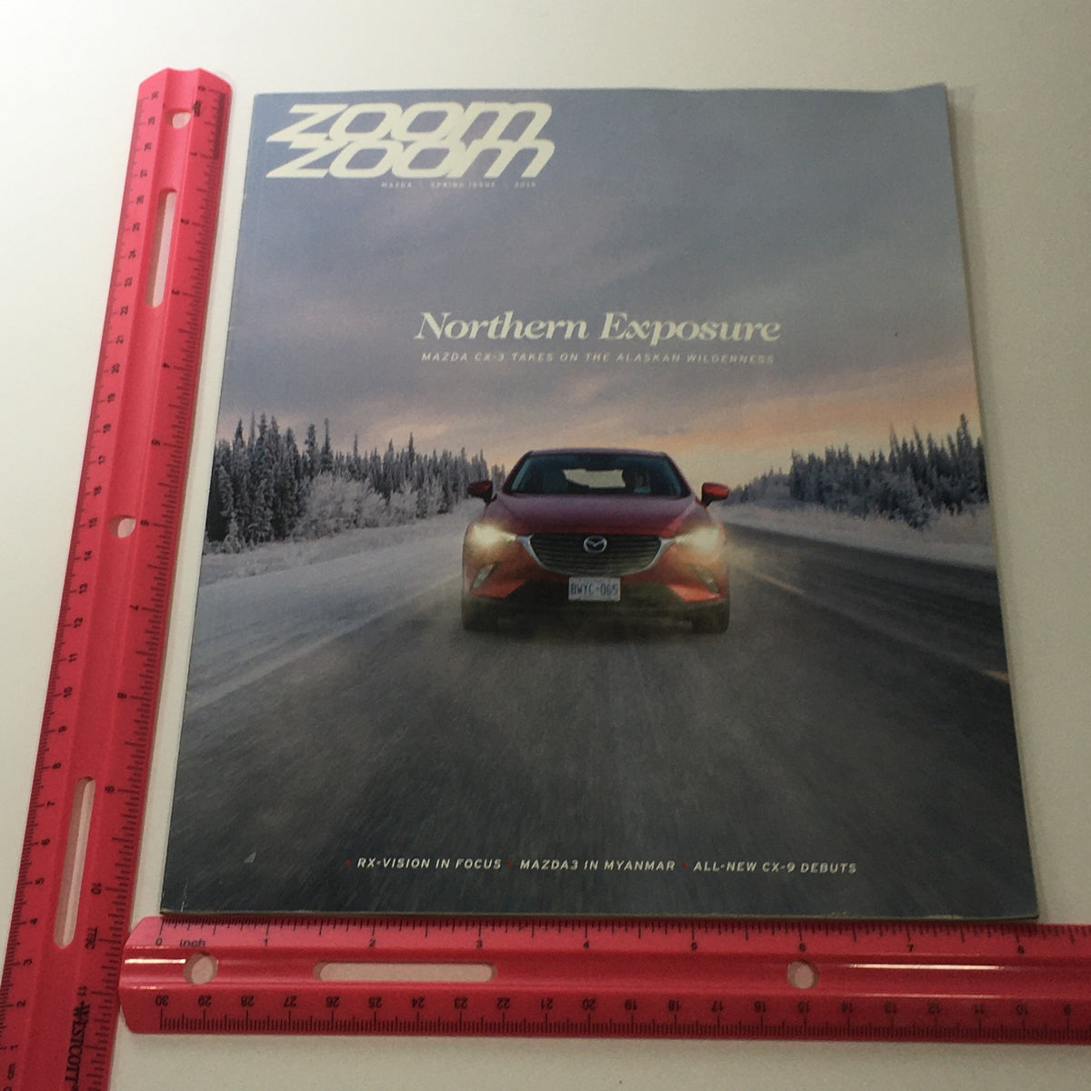Spring 2016 Mazda RX-Vision CX-9 Debuts dealership car catalog brochure cover featuring the title 'Northern Exposure' with a Mazda vehicle set against a snowy landscape, highlighting the brand's adventurous spirit.