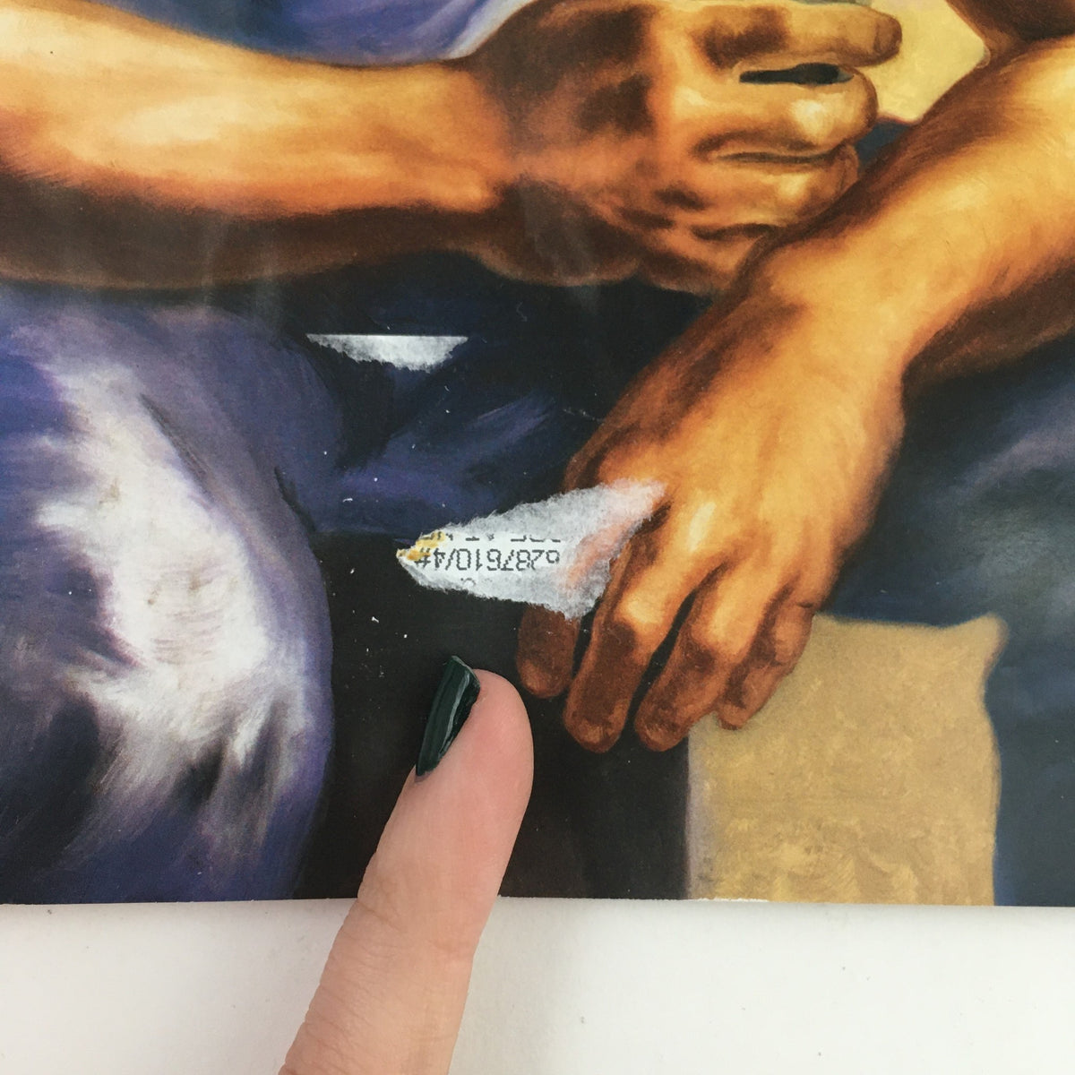Close-up detail of the artwork on The New Yorker April 20 2020 magazine, showcasing a man's hands with a prominent label, part of the cover art by Owen Smith.