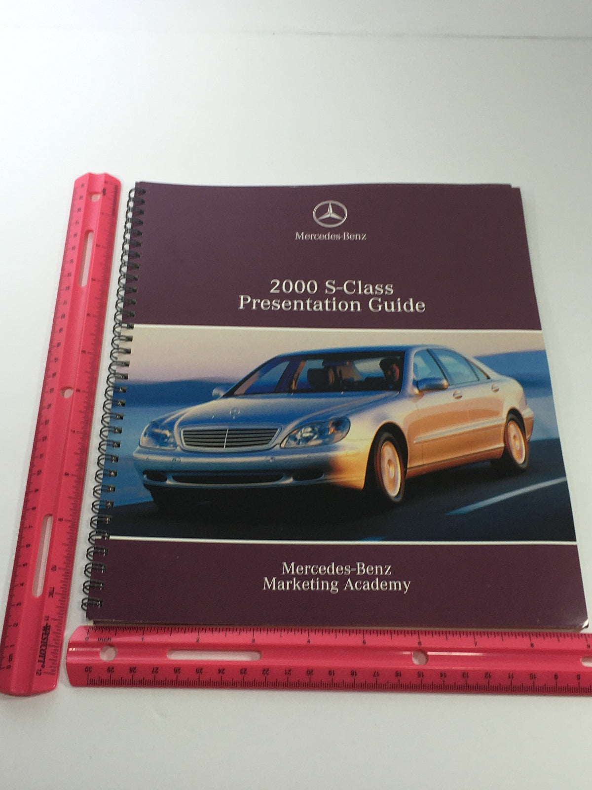 Cover of the 2000 Mercedes-Benz S-Class Presentation Guide, highlighting the sleek design of the vehicle and branding from the Mercedes-Benz Marketing Academy.