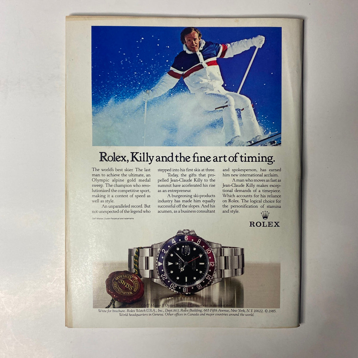 Advertisement page from Forbes Magazine, February 24, 1986, showcasing a Rolex ad with an Olympic skier, emphasizing luxury and performance.