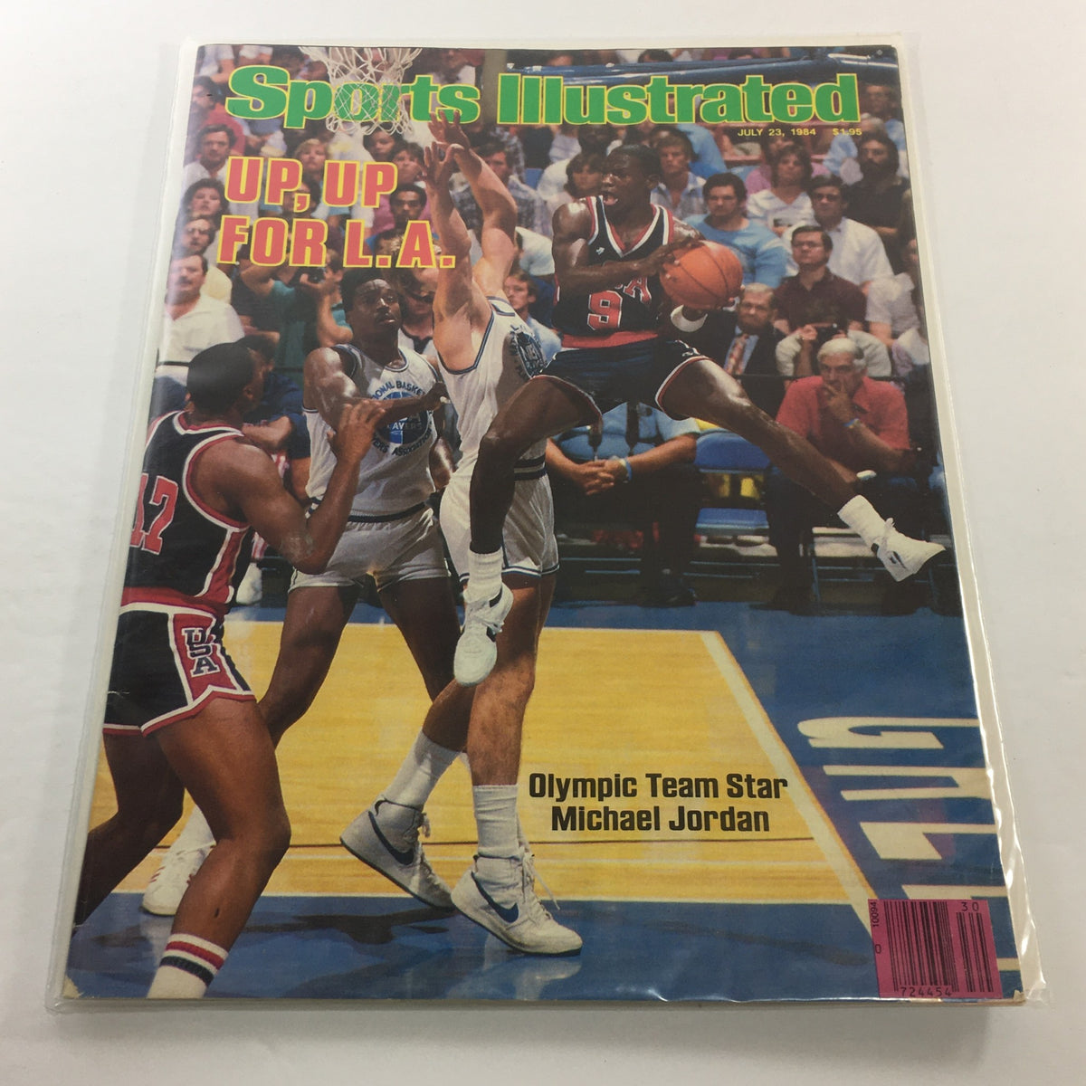 Sports Illustrated cover from July 23, 1984, featuring Olympic Team Star Michael Jordan soaring for a basket with the headline 'Up, Up For L.A.' showcasing a pivotal moment in basketball history.