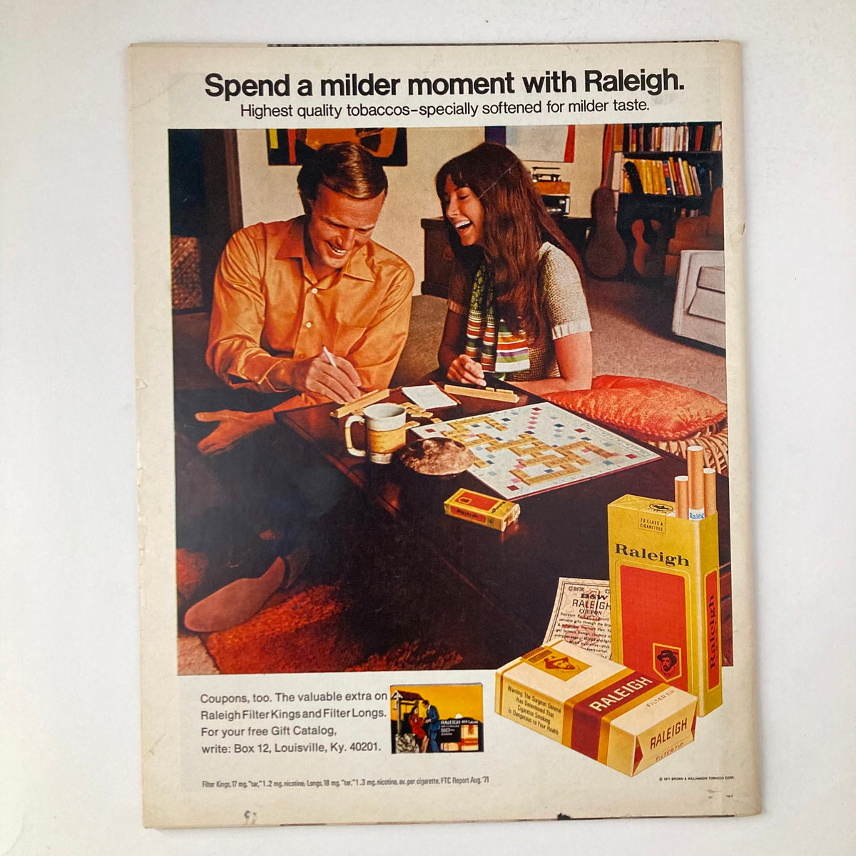 Back cover of VTG Life Magazine December 10 1971, featuring an advertisement for Raleigh cigarettes, depicting a couple enjoying a game night, symbolizing social moments of the early 1970s.