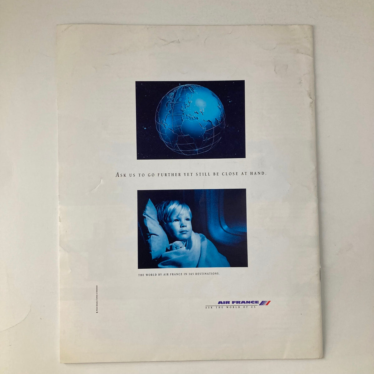 Back cover of France Magazine Spring 1993 No. 26, featuring an advertisement for Air France with a child looking out the airplane window and the tagline about exploring the world.