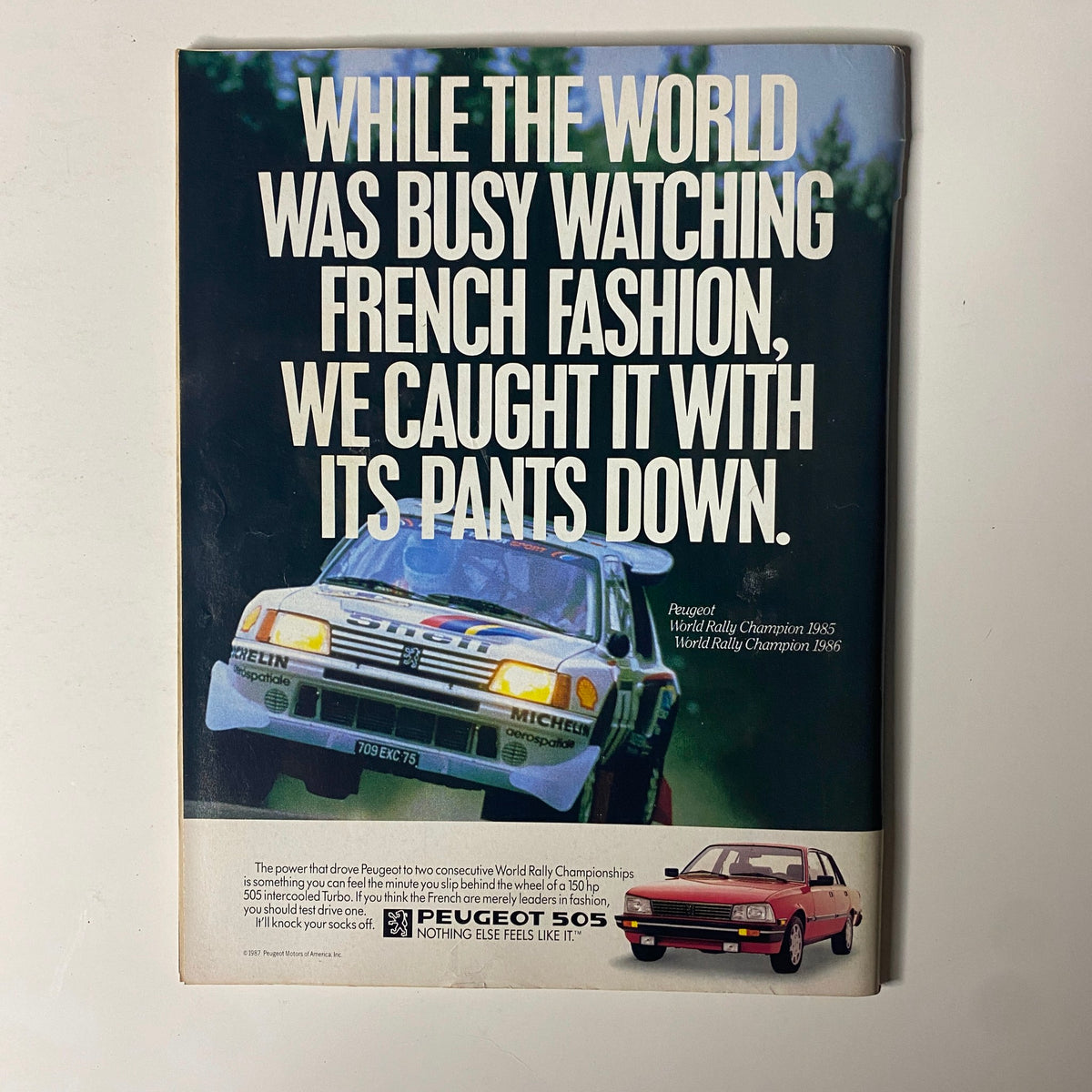 Advertisement in Forbes Magazine March 9, 1987 for Peugeot showcasing their rally championship vehicles.