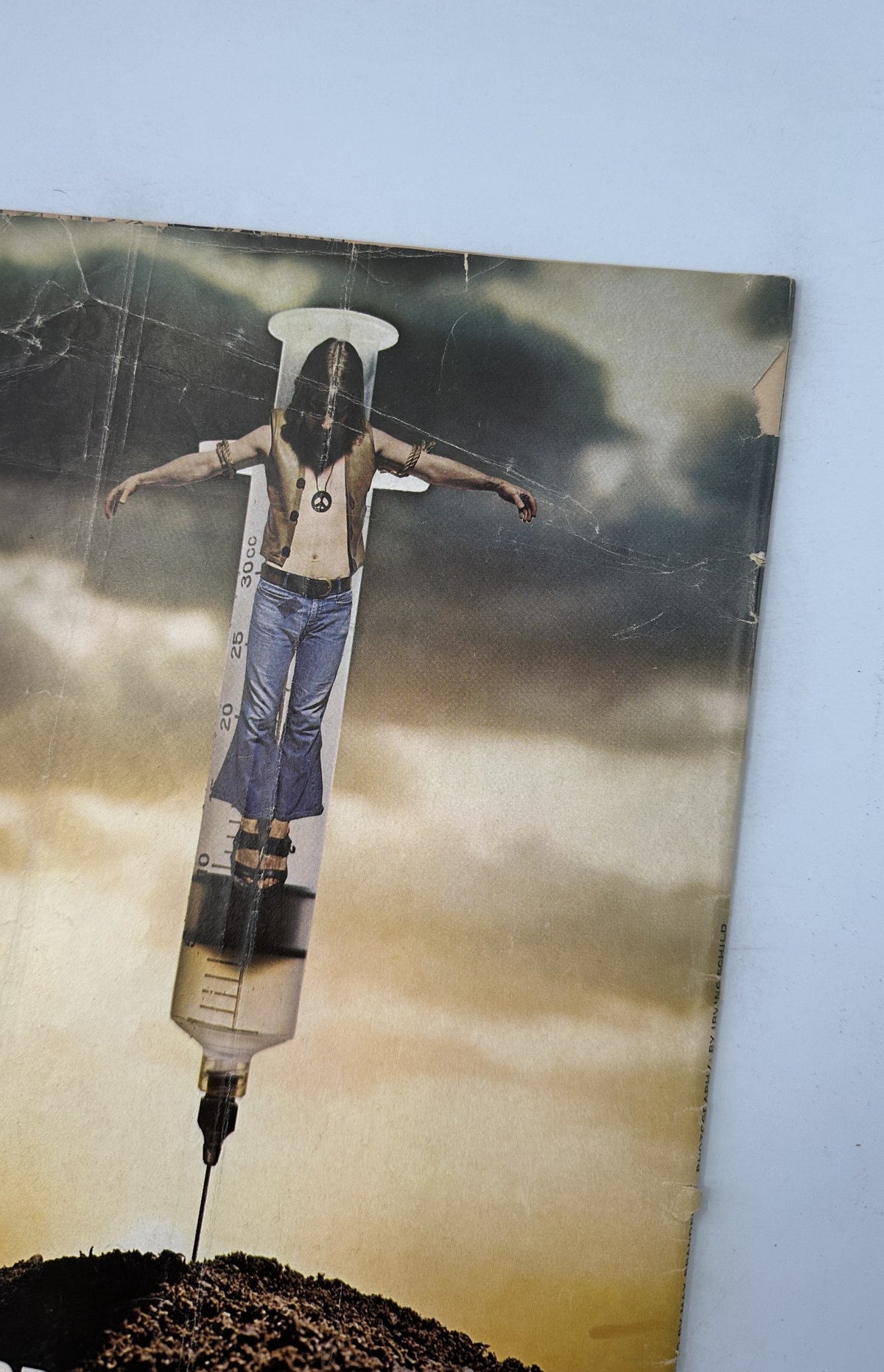 Detailed view of the back cover of MAD Magazine No. 145 from September 1971, depicting a figure on a syringe in a dramatic landscape marked by controversy.