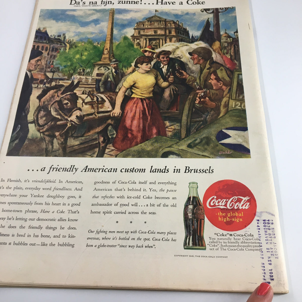 Back cover of Life Magazine June 4, 1945 showcasing a Coca-Cola advertisement with a colorful illustration depicting a friendly interaction in Brussels post-World War II.