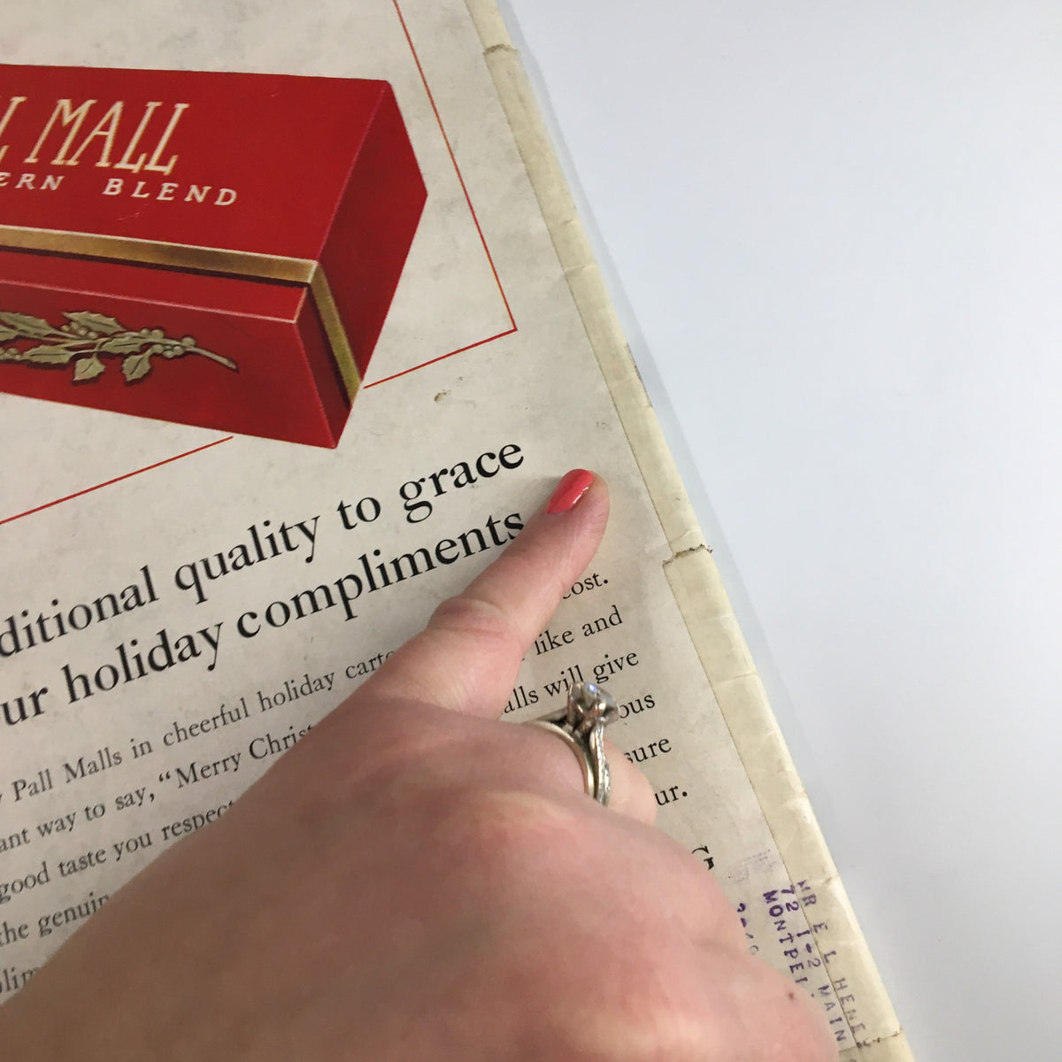 Close-up detail of VTG Life Magazine December 20 1937 cover, showing hand pointing to text about holiday compliments, highlighting vintage design elements.