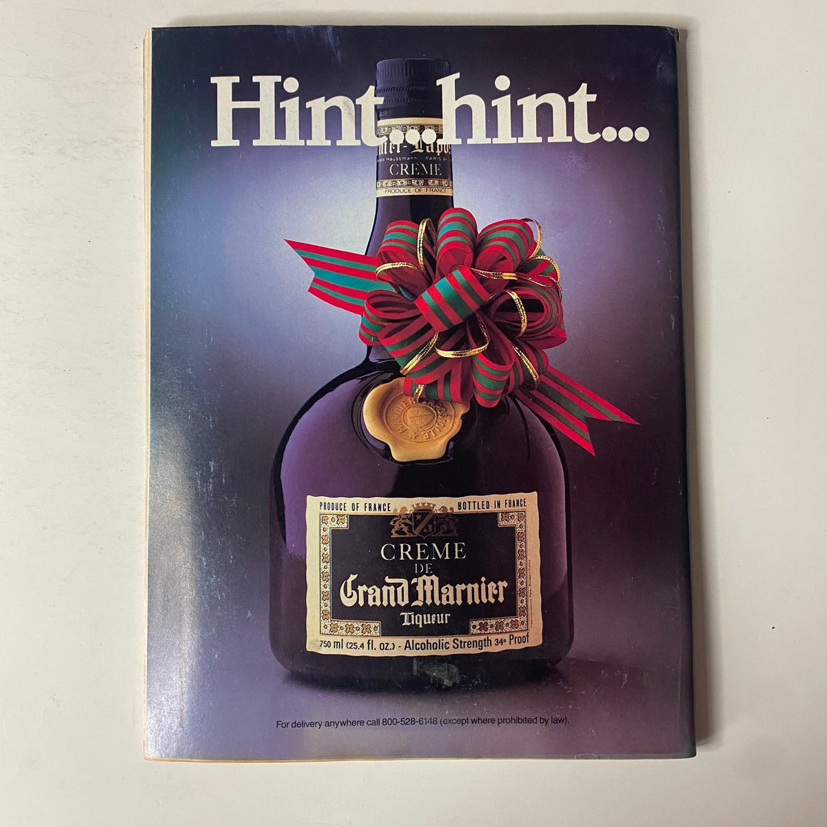 Advertisement for Grand Marnier liqueur from Forbes Magazine December 19, 1983, featuring a decorative bottle and festive bow.