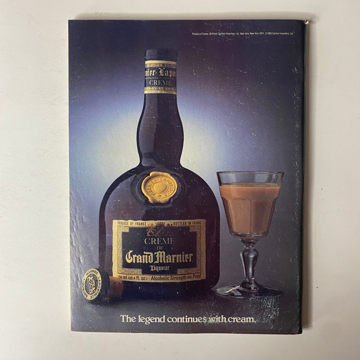 Advertisement in Forbes Magazine October 10, 1983 for Grand Marnier liqueur featuring a bottle and glass, highlighting the tagline 'The legend continues with cream.'