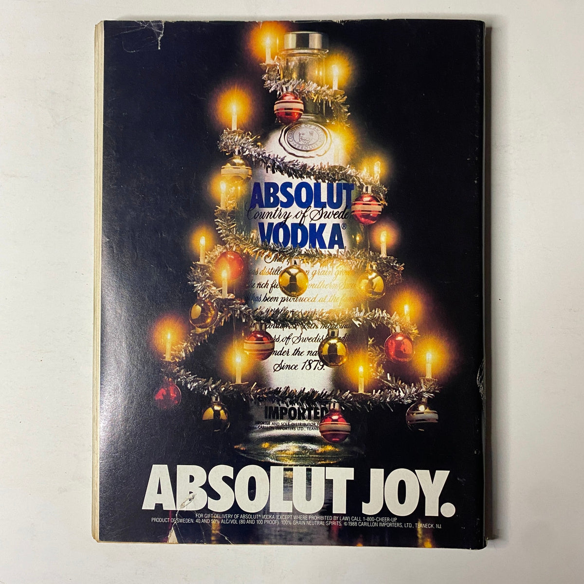 Cover of Forbes Magazine December 12, 1988 featuring an interview with Milton Friedman, showcasing a festive advertisement for Absolut Vodka with holiday decorations and candles.