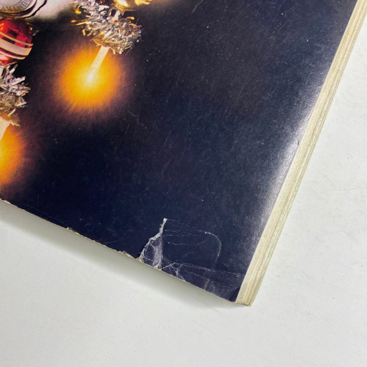 Detail view of the cover of Forbes Magazine December 12, 1988 highlighting an interview with Milton Friedman, including an Absolut Vodka advertisement adorned with Christmas ornaments and lights.