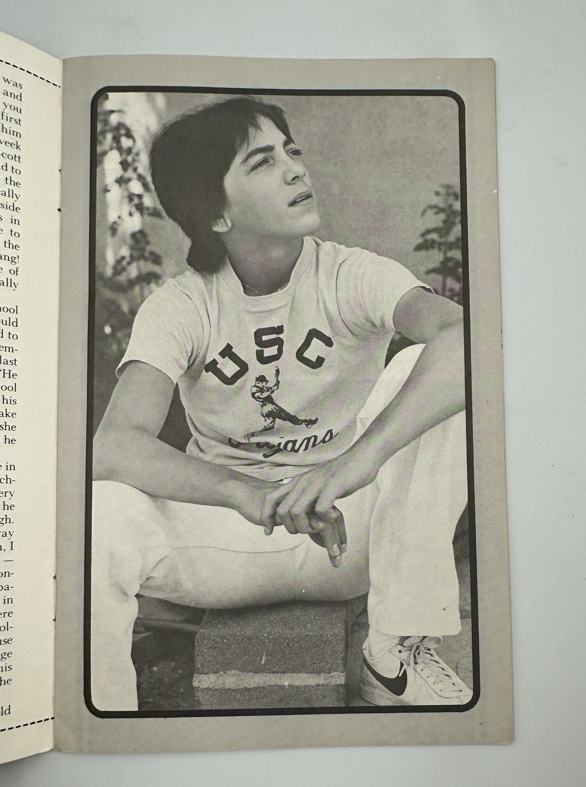 Black and white photograph of Scott Baio in a USC t-shirt, sitting in a thoughtful pose. This image is part of 'The Secret of Scott Baio' magazine, capturing the essence of the teen idol from Happy Days.