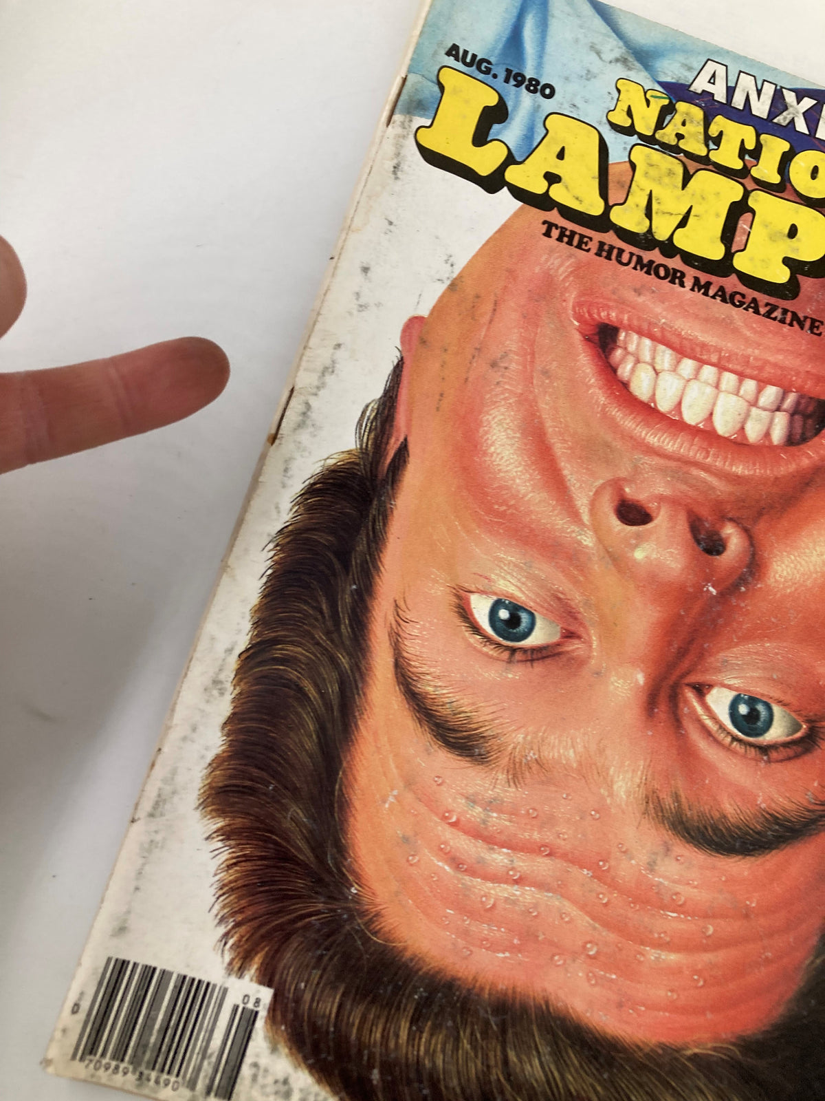 Side view of National Lampoon Humor Magazine August 1980 highlighting the wear on the cover, emphasizing its collectible nature.