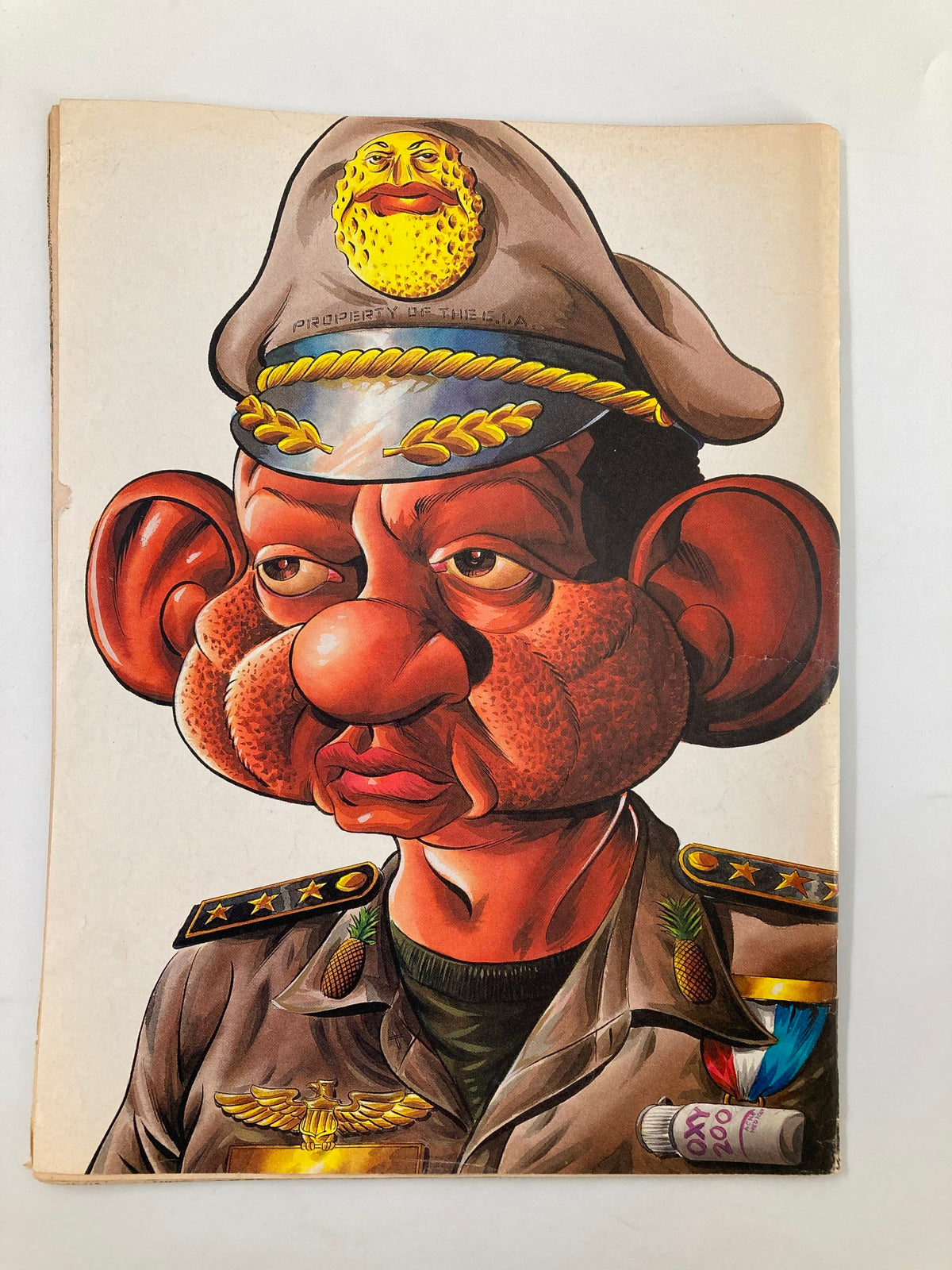 Cover page of the Cracked Humor Magazine July 1990 caricaturing a character in military attire with exaggerated features, representing the humorous and satirical artwork typical of the magazine.