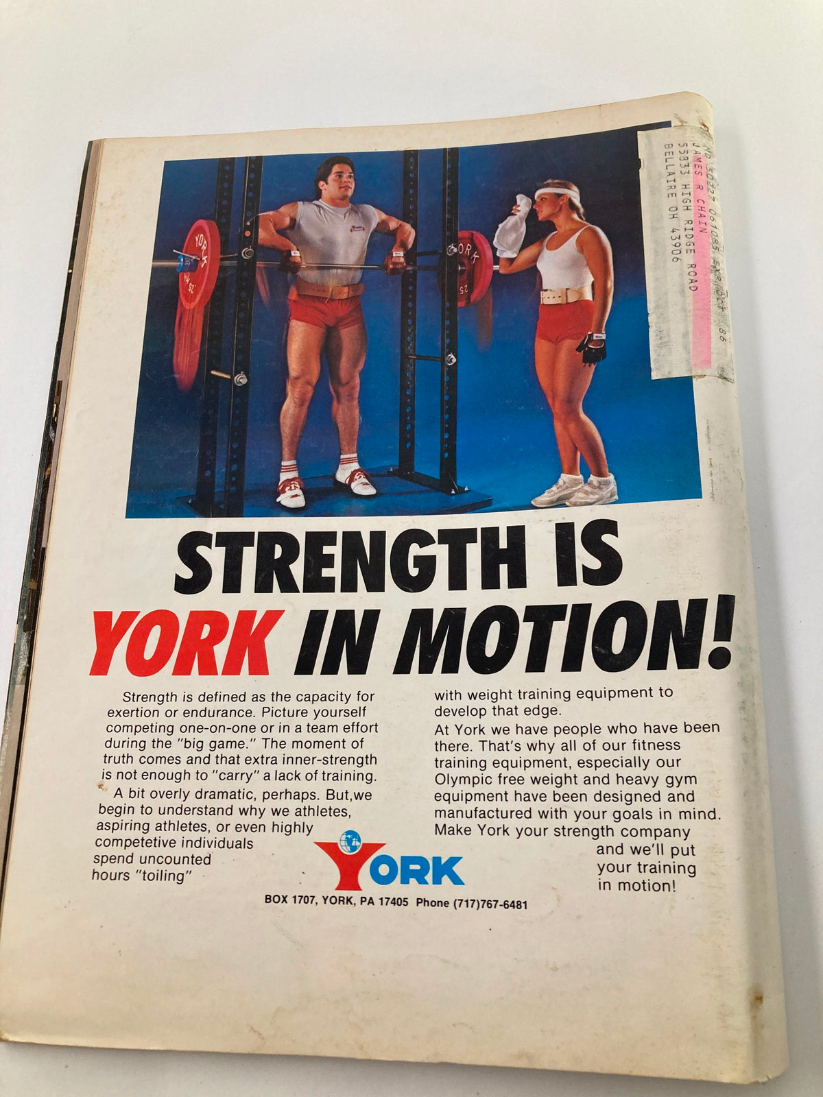 Advertisement page from VTG Muscular Development Magazine October 1985 for York fitness equipment, depicting a male and female athlete demonstrating weight training.