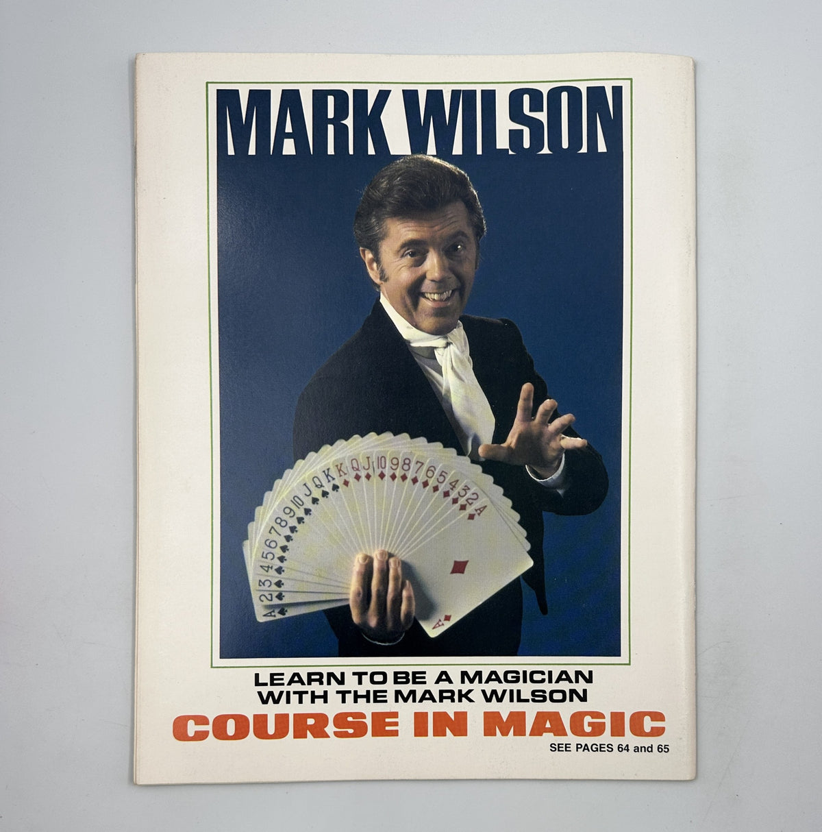 Magician Mark Wilson featured in The Magic Magazine March 1975, promoting a course in magic with a display of cards.