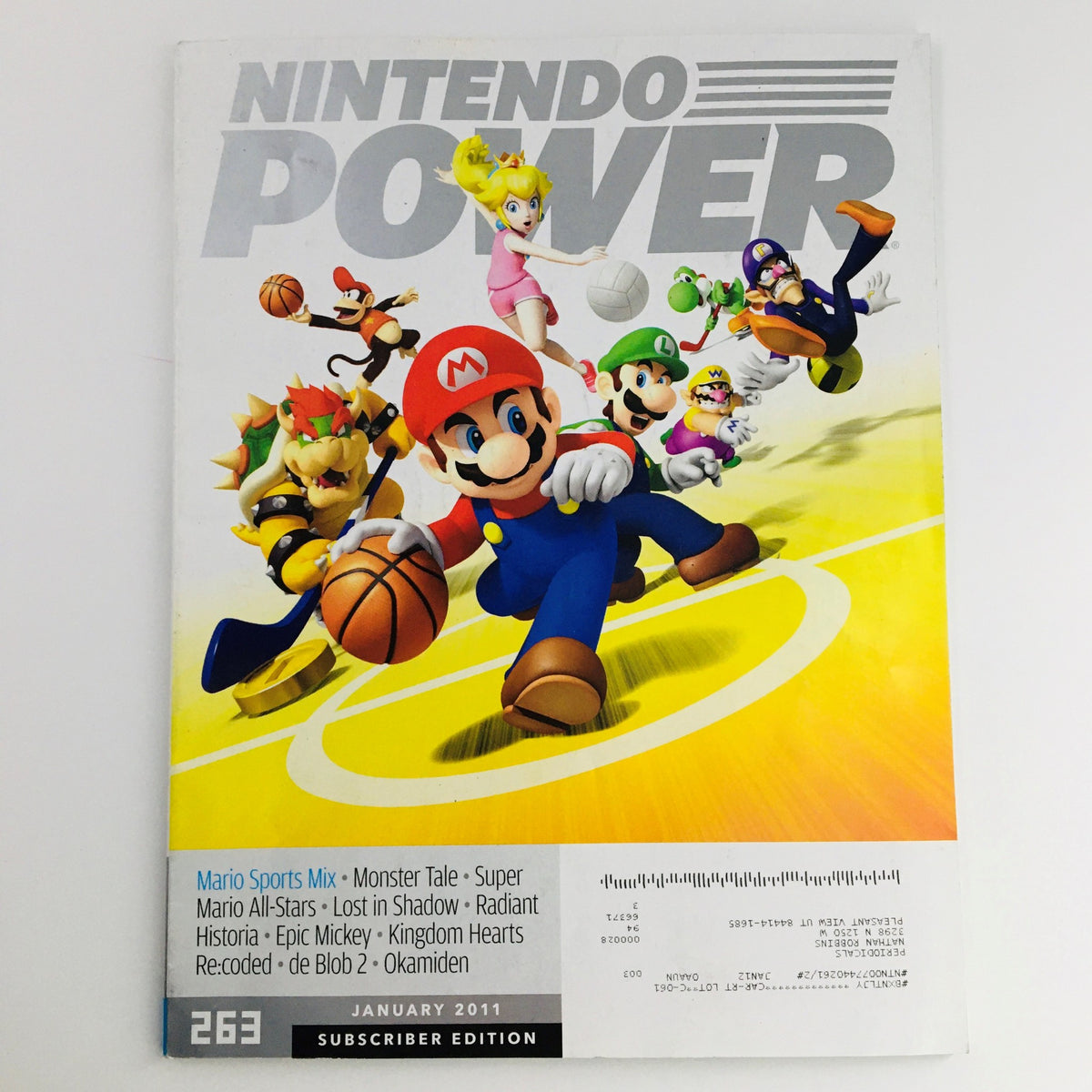 Cover of Nintendo Power Magazine January 2011 featuring Mario Sports Mix and Monster Tale. The cover showcases Mario and other characters engaged in sports.