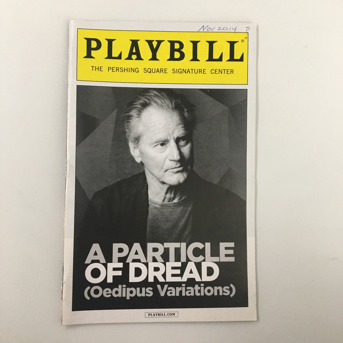 Cover image of the 2014 Playbill for "A Particle of Dread: Oedipus Variations" by Sam Shepard, featuring a portrait of a male actor against a geometric background.