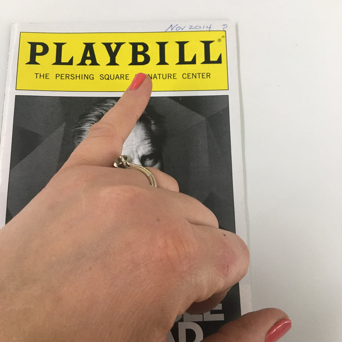 Close-up of the 2014 Playbill for "A Particle of Dread: Oedipus Variations" showing the title in bold text along with the theater name, The Pershing Square Signature Center.