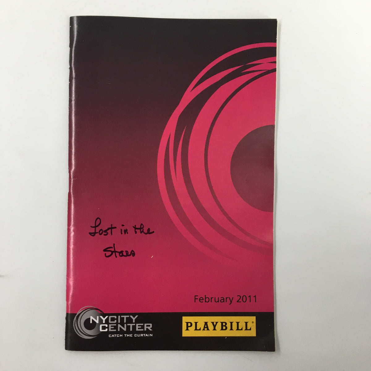 2011 Playbill for Lost In The Stars, directed by Gary Griffin, featuring a pink cover with circular design elements.