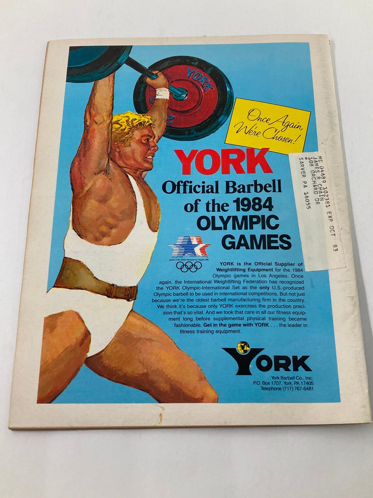 Back cover of VTG Muscular Development Magazine April 1983 Vol 20 #2, featuring an advertisement for York Official Barbell of the 1984 Olympic Games, illustrating vintage fitness equipment and promotion of Olympic weightlifting.