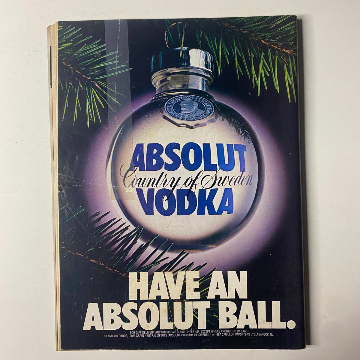 Advertisement page from Forbes Magazine December 14, 1987, featuring a visually striking Absolut Vodka ad with seasonal decoration.
