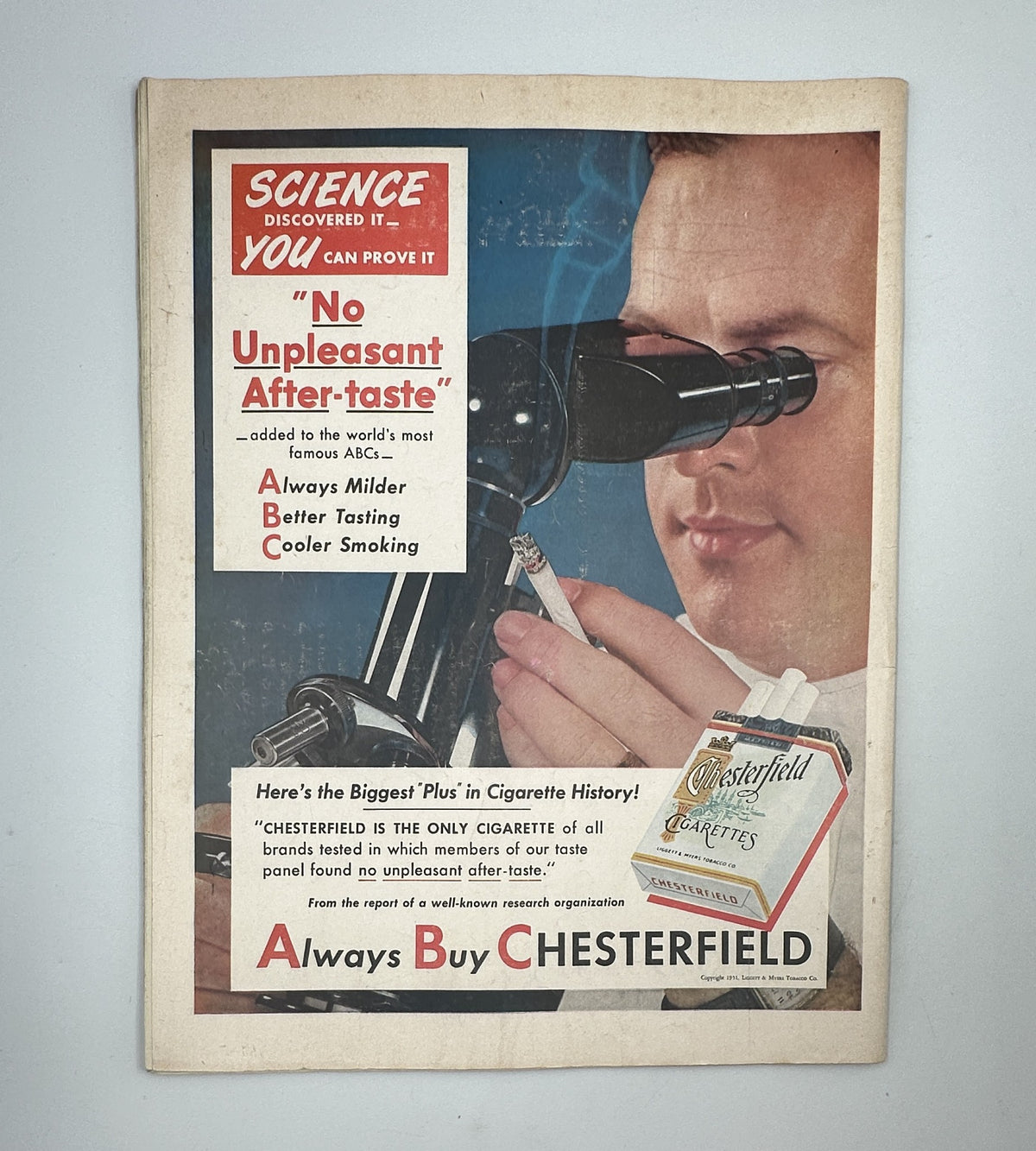 Back cover of Collier’s Magazine November 10, 1951, advertising Chesterfield cigarettes with a scientific theme and a man using a microscope.