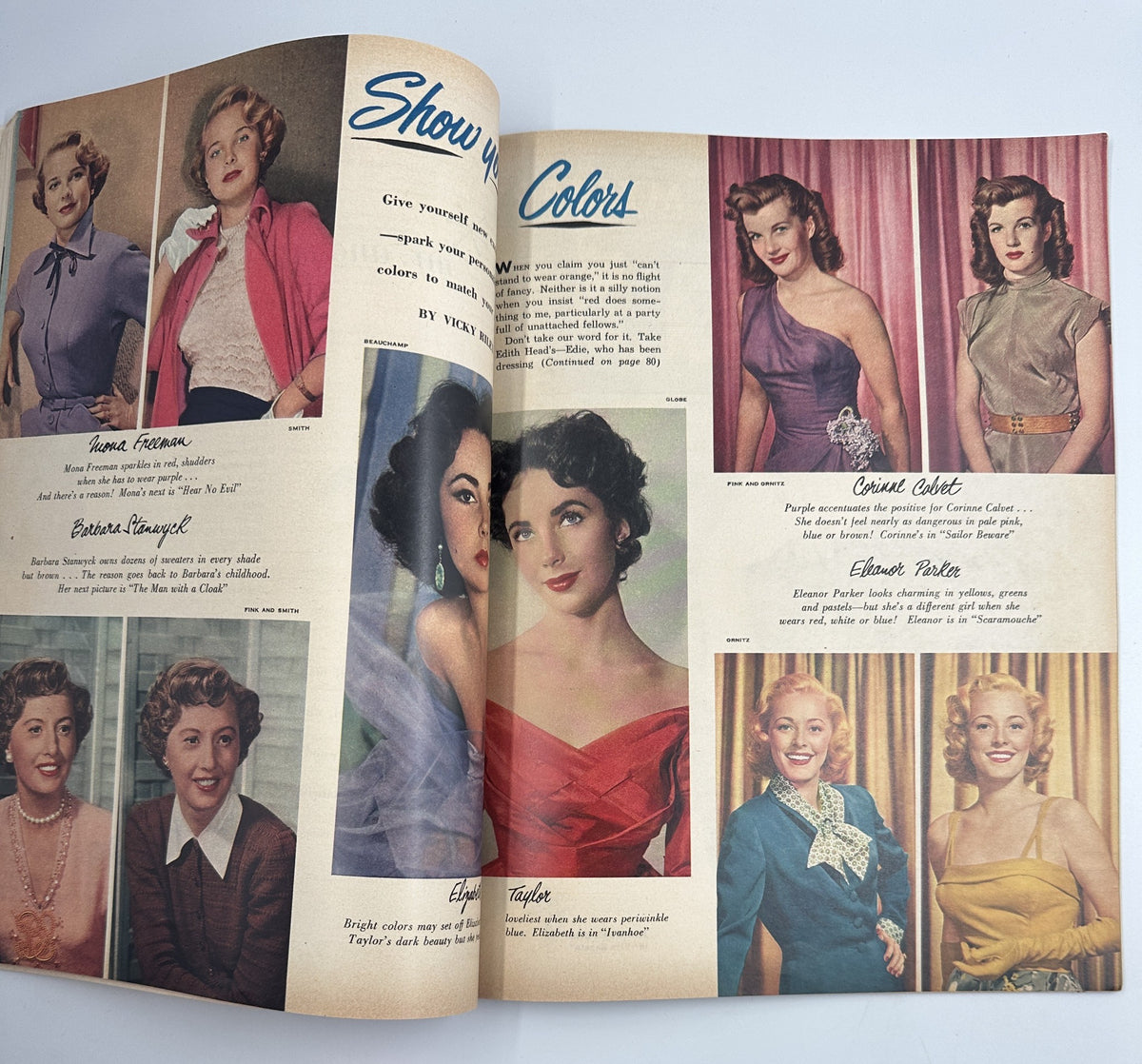 Photoplay Magazine March 1952 featuring a fashion spread titled 'Show Your Colors' with models showcasing various outfits. Highlights include stylish clothing styles from the era, featuring well-known actresses like Elizabeth Taylor and Claudette Colbert.
