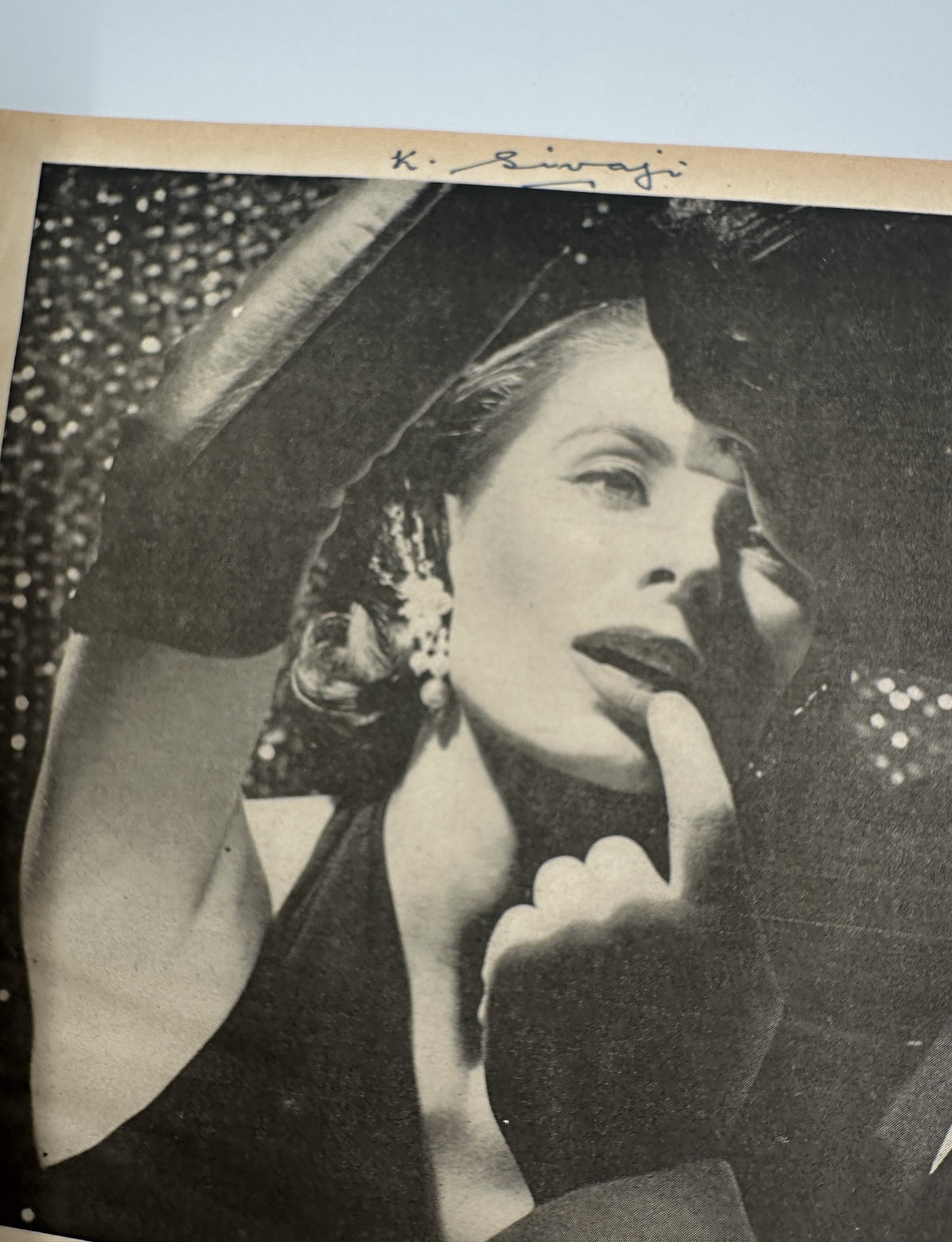 Photoplay Magazine March 1957 featuring a glamorous black and white image of a woman with stylish makeup and earrings, emphasizing beauty and elegance.
