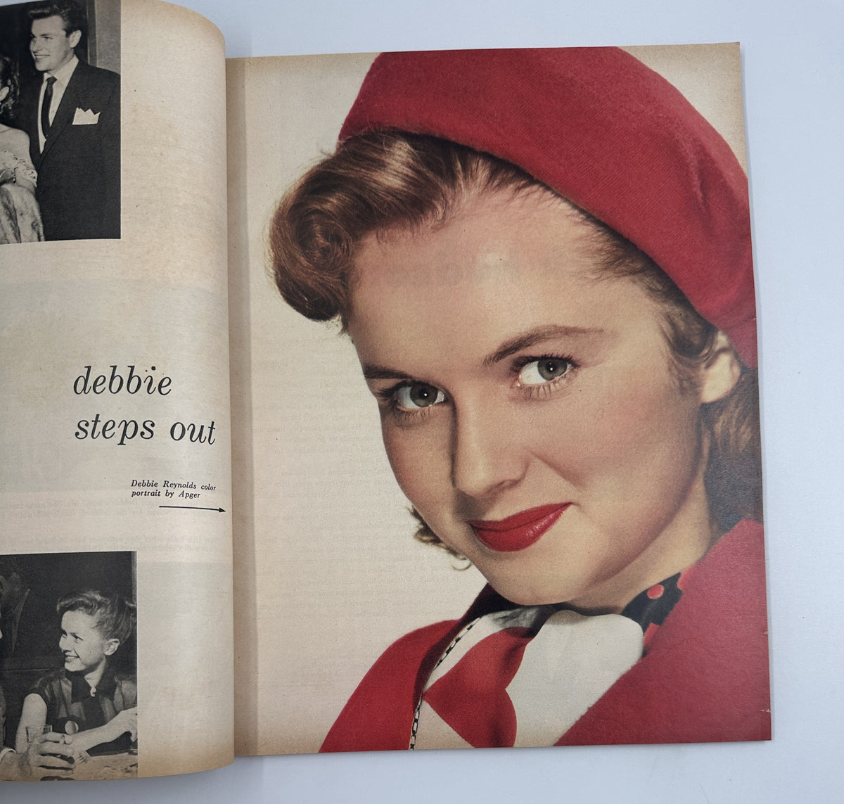 Debbie Reynolds graces the pages of the 1953 Photoplay Annual Magazine with a vibrant photo portrait, adorned in a stylish red hat and a matching outfit, under the headline 'Debbie Steps Out'.