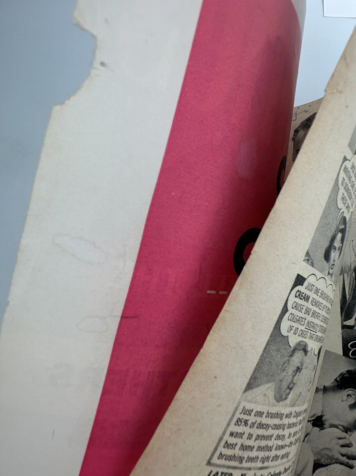 Close-up of the corner of a page in Screen Stories Magazine September 1953 displaying a tear on the edge of the paper, indicating its vintage condition.