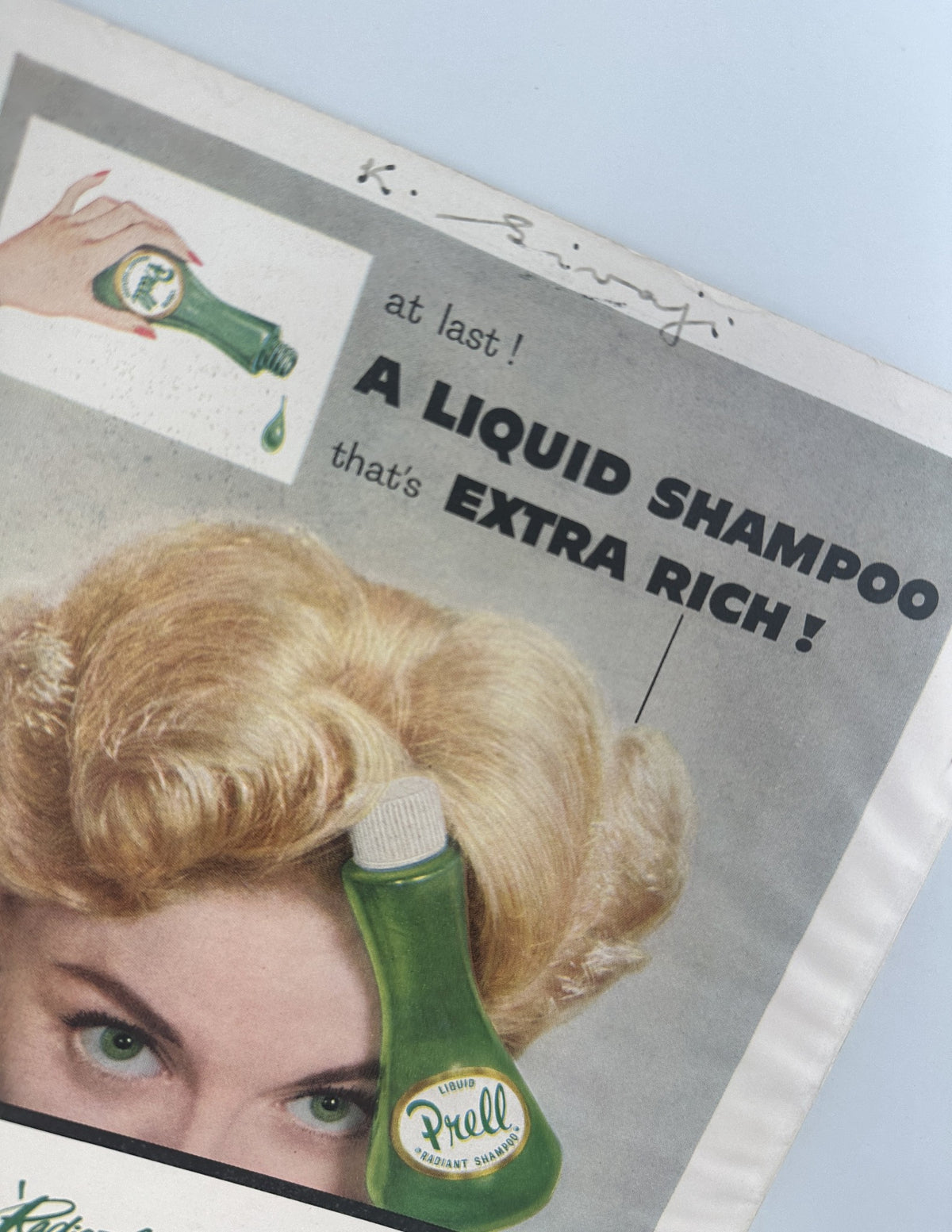 Vintage advertisement for Prell Liquid Shampoo, featuring a woman with blonde curls promoting the product. The ad states 'at last! A LIQUID SHAMPOO that's EXTRA RICH!' from the Screen Stories Magazine July 1956.