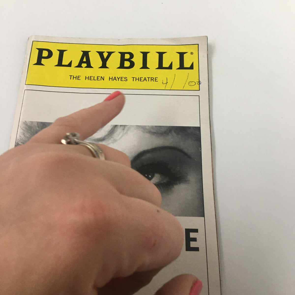 Hand pointing at the 2000 Playbill for 'Dirty Blonde' at the Helen Hayes Theatre, highlighting the playbill's title and condition.