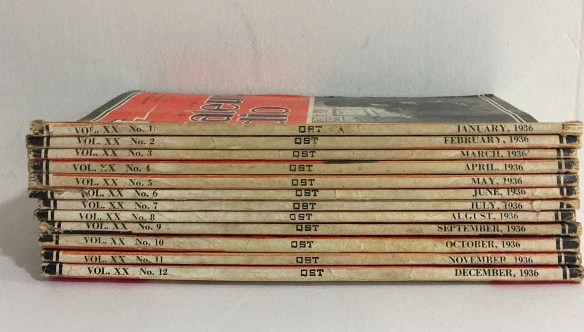 Spine view of Lot of 12 Complete January to December 1936 QST Amateur Radio magazines, highlighting the month and volume numbers printed on each magazine's spine.