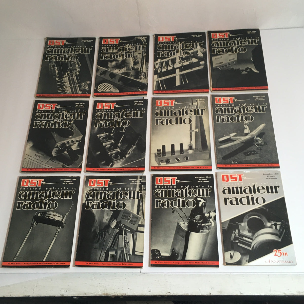 Lot of 12 January to December 1940 QST Amateur Radio magazines showcasing covers and themes of amateur radio technology and trends.