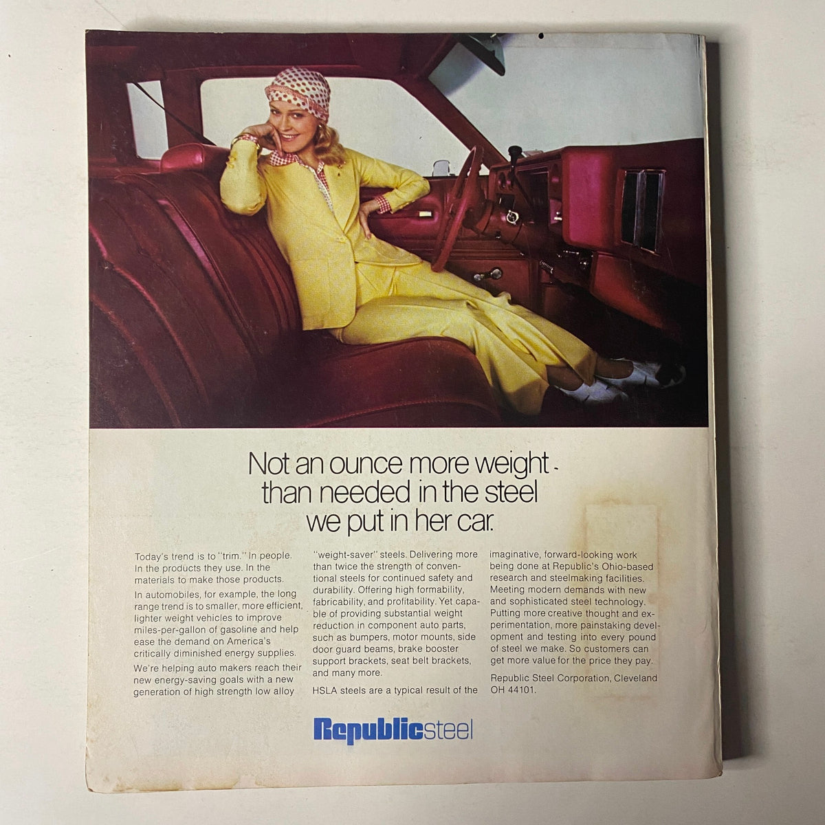 Back cover of Fortune Magazine May 1977 featuring an advertisement for Republic Steel. The ad portrays a woman in a vibrant yellow outfit seated in a stylish car interior, emphasizing the lightweight steel used in automotive manufacturing with the tagline about efficiency and safety.