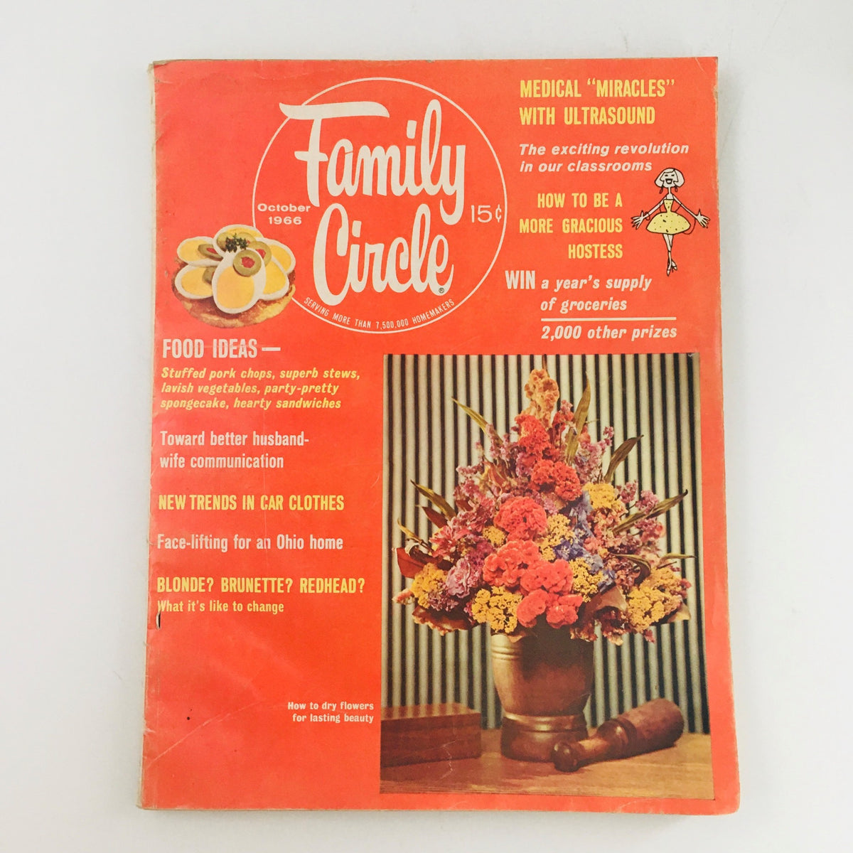 Cover of Woman's Day Magazine October 1966, featuring a floral arrangement and the article 'How to Dry Flowers for Lasting Beauty'. The magazine includes tips for home decor and crafting enthusiasts.