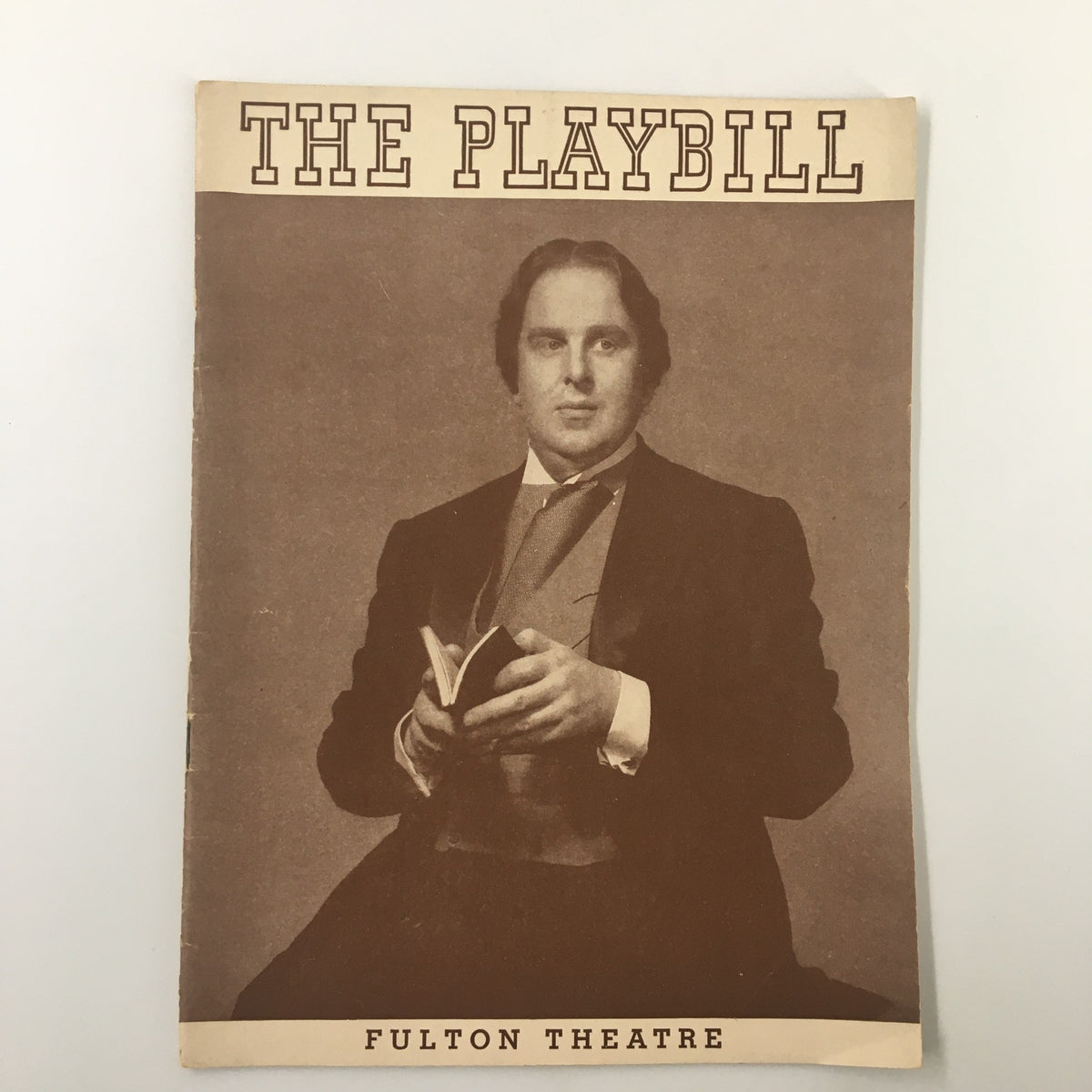 Cover of the 1939 Playbill from the Fulton Theatre featuring Oscar Wilde, showcasing a vintage portrait of a gentleman in formal attire holding a book.