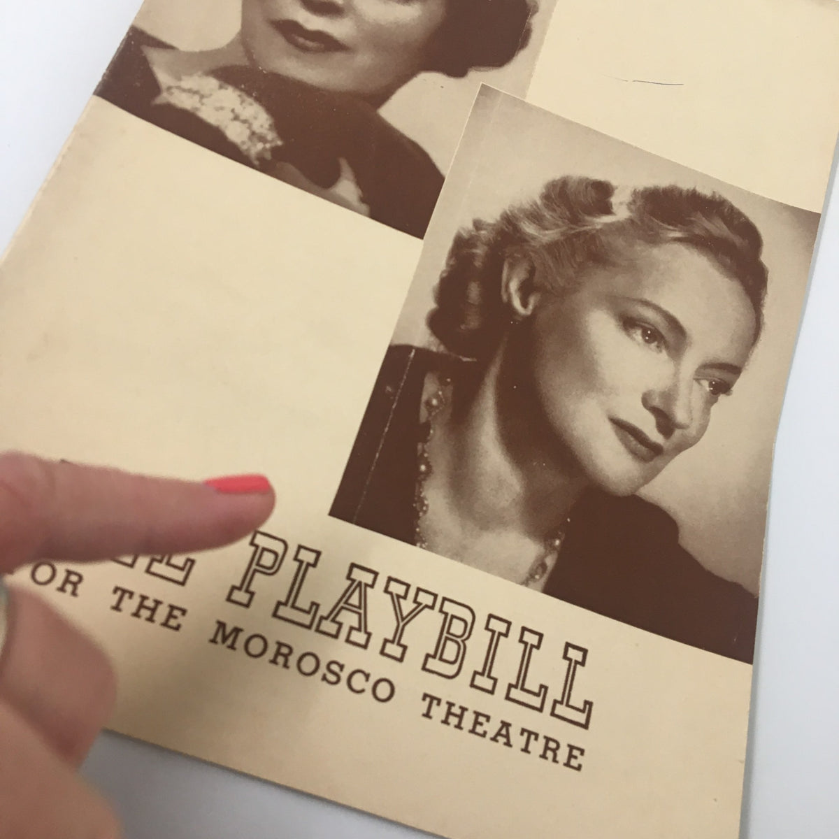 Close-up of the 1941 Playbill cover for Morosco Theatre displaying Jane Cowl's photograph and a finger pointing at the cover.