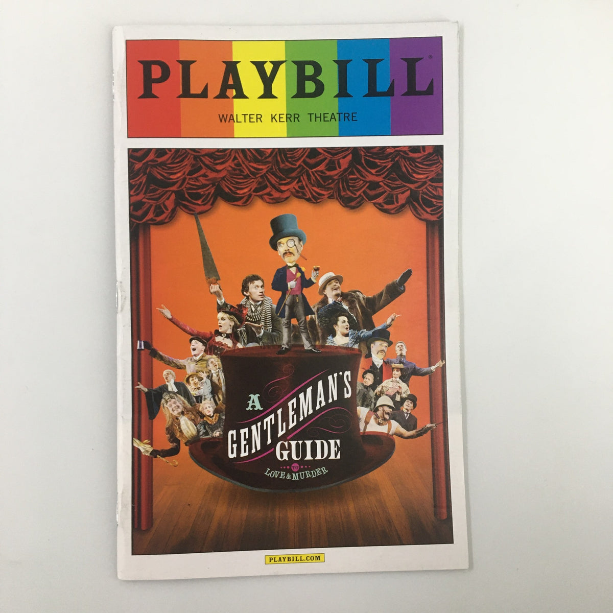 2014 Playbill for A Gentleman's Guide To Love & Murder at Walter Kerr Theatre, showcasing vibrant artwork and characters from the musical.