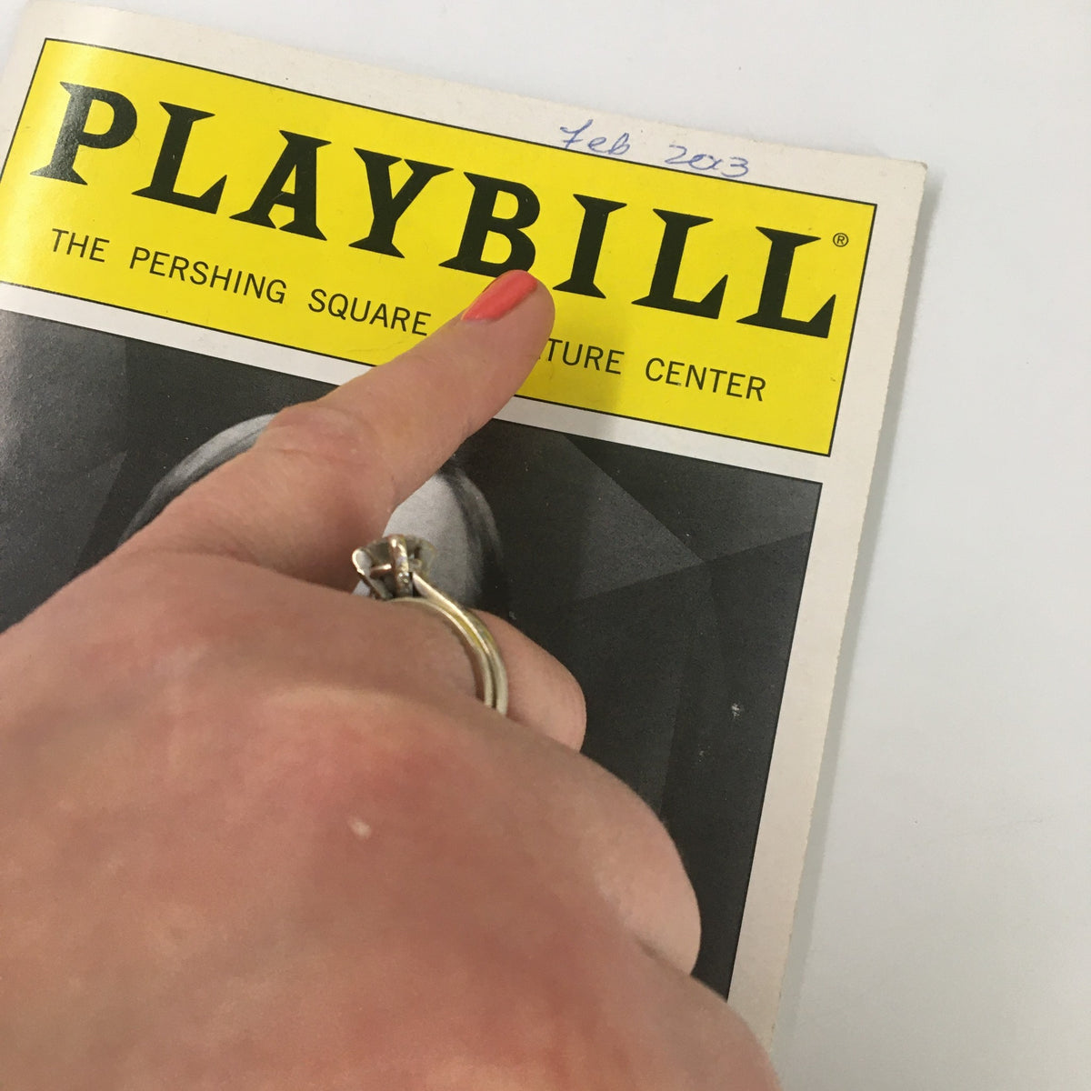 Close-up of the 2003 Playbill for The Mound Builders showing the date February 2013 and a hand pointing at the title.