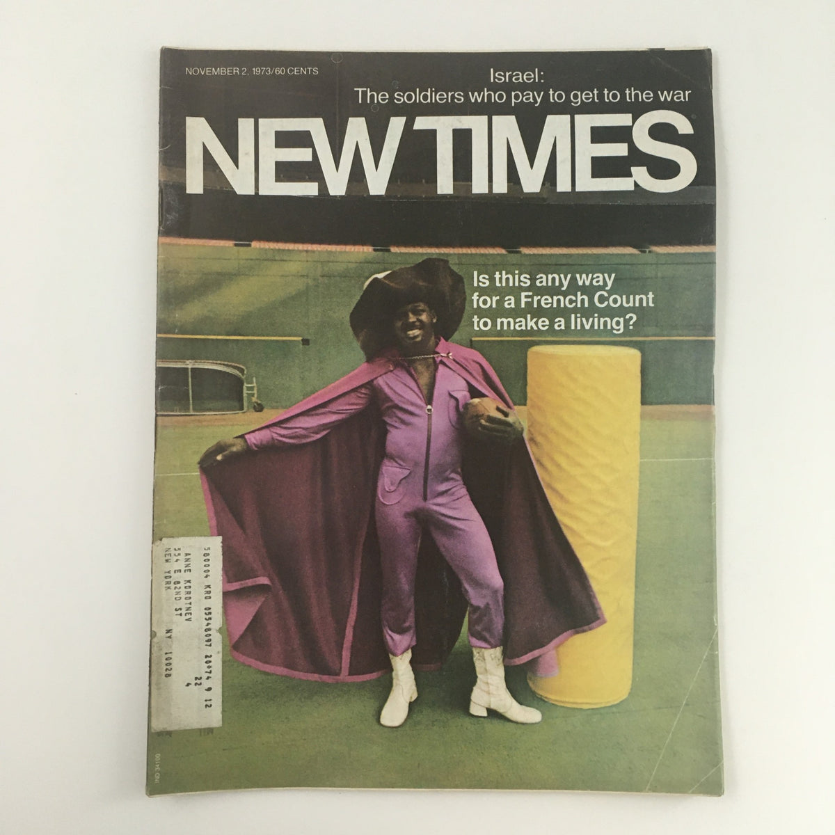 Cover of New Times Magazine from November 2, 1973, featuring the title 'Israel: The soldiers who pay to get to the war'. The cover showcases a man in a purple outfit and hat, striking a pose with a playful expression, highlighting a unique historical perspective on military service.
