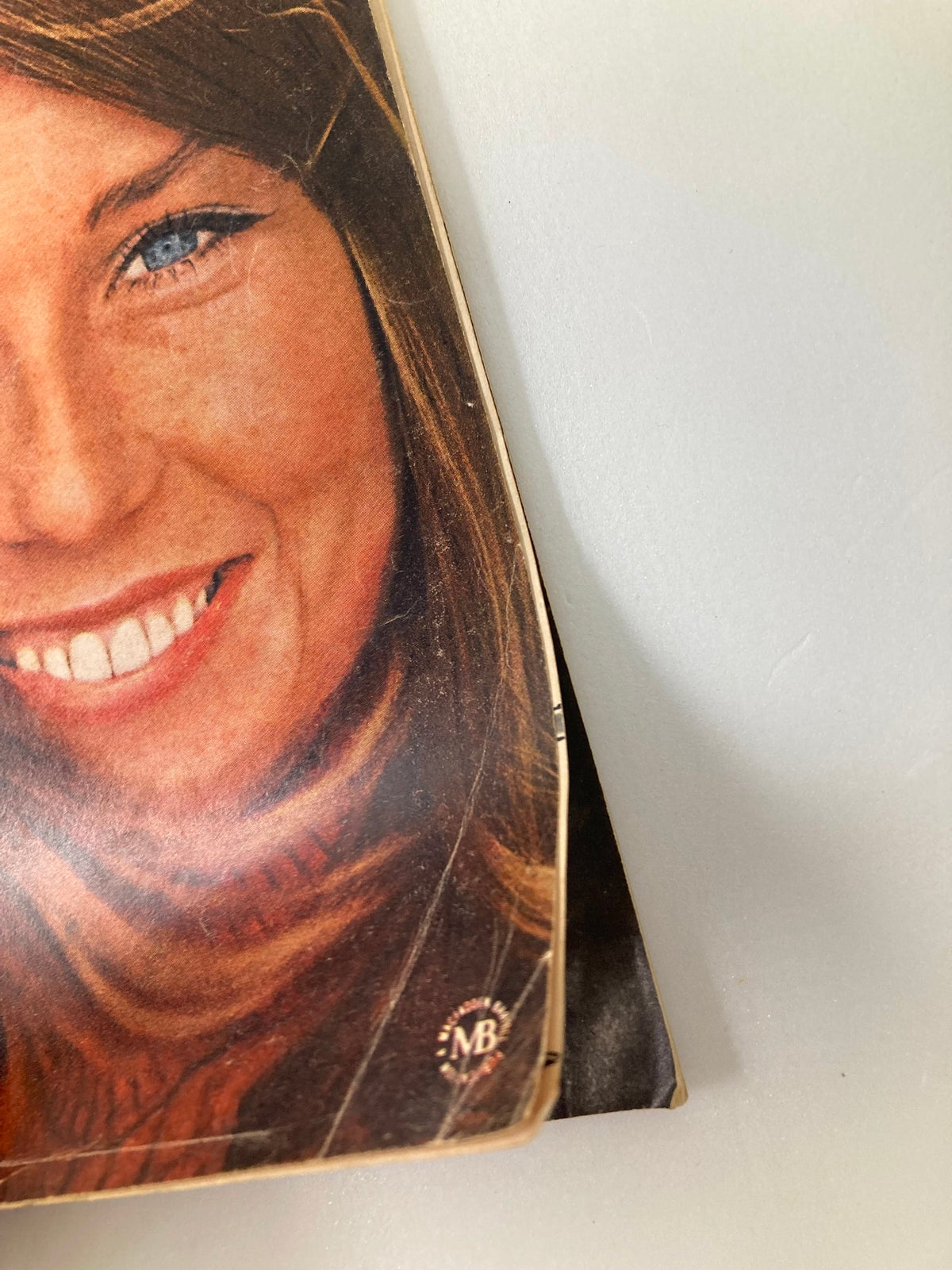 Side view of the front cover of VTG IN Magazine March 1966 showcasing the smiling woman and magazine's branding.