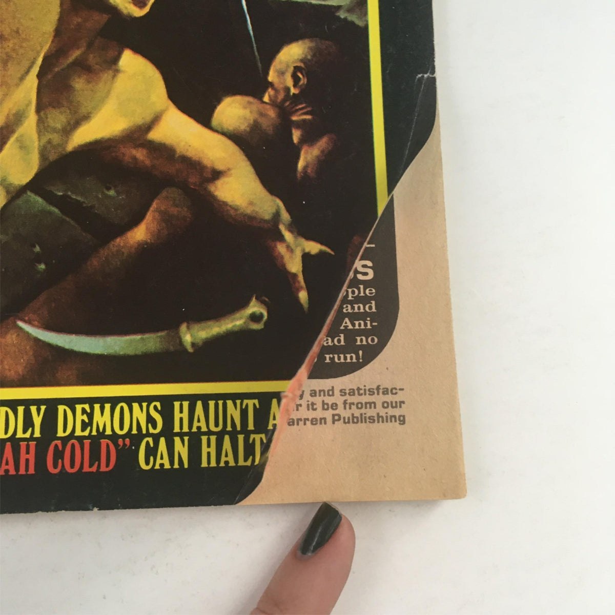 Close-up of the corner of Eerie Magazine February 1976 #72 highlighting the tagline about demons and featuring a gripping illustration.
