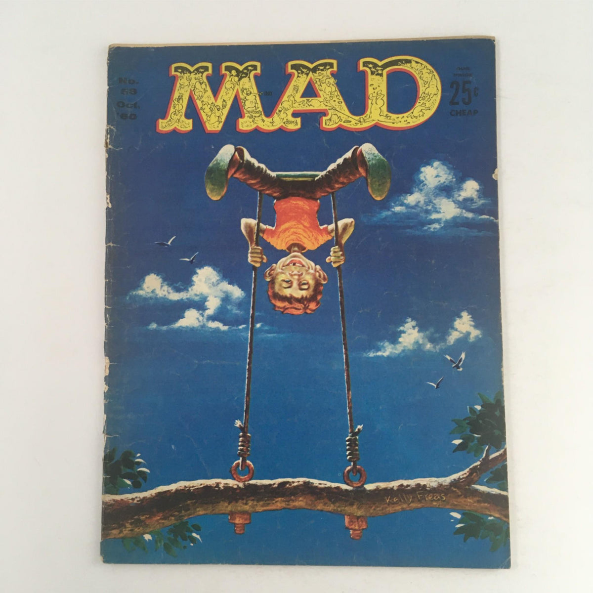 Mad Magazine October 1960 No. 58 cover featuring Alfred E. Neuman on a swing under a bright blue sky, capturing the whimsical humor associated with the magazine.