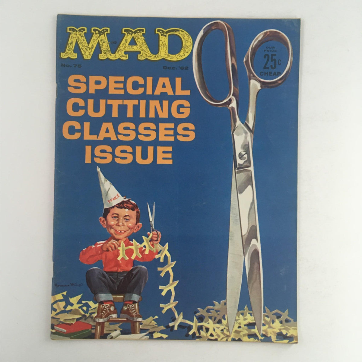 Mad Magazine December 1962 No. 75 Cutting Classes Issue cover featuring a cartoon character with scissors, a dunce hat, and cut paper, embodying the humor of the edition.