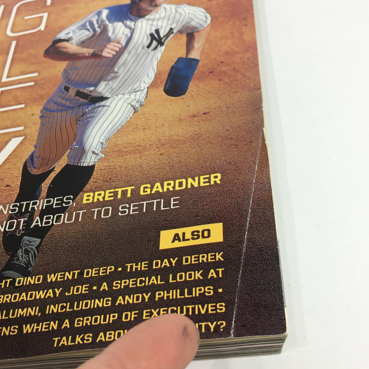 Close-up of the Yankees Magazine May 2014 Volume #35-3 showcasing additional content including a Jacoby Ellsbury poster and text about various players, emphasizing Brett Gardner's prominence.