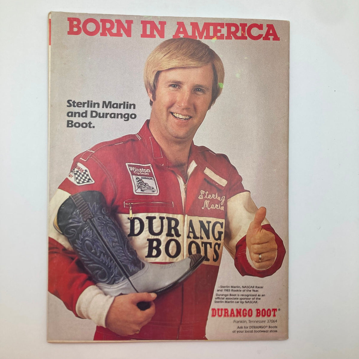 Back cover of the VTG Stock Car Racing Magazine December 1986 promoting Durango Boots with a photograph of NASCAR racer Sterling Marlin holding a boot, emphasizing its connection to the racing culture.