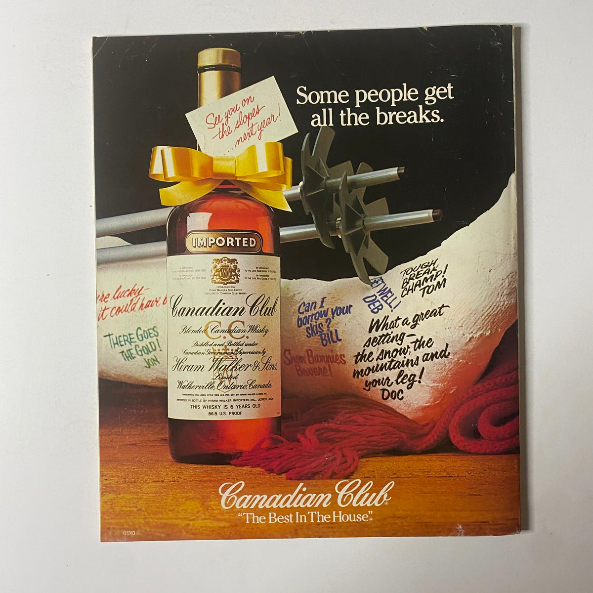 Retro advertisement for Canadian Club whisky, featuring a bottle and playful text promoting the brand, from a vintage magazine issue. The tagline states, 'Some people get all the breaks.'