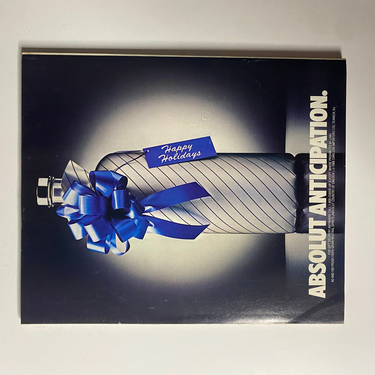 Cover of Fortune Magazine December 8, 1986 showcasing a festive Absolut Vodka advertisement themed 'Happy Holidays', featuring a wrapped bottle with a blue bow.